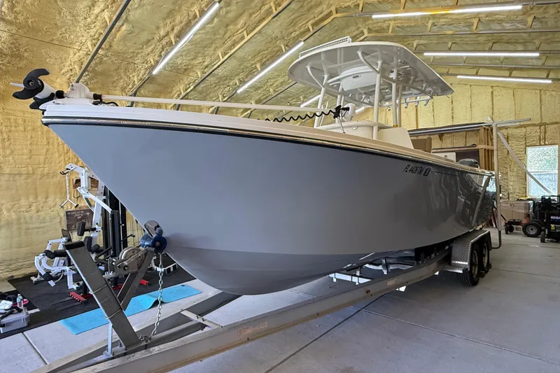 Slide: The Image of 2022 Parker 2501 Center Console boat on trailer in a garage setting. - 3