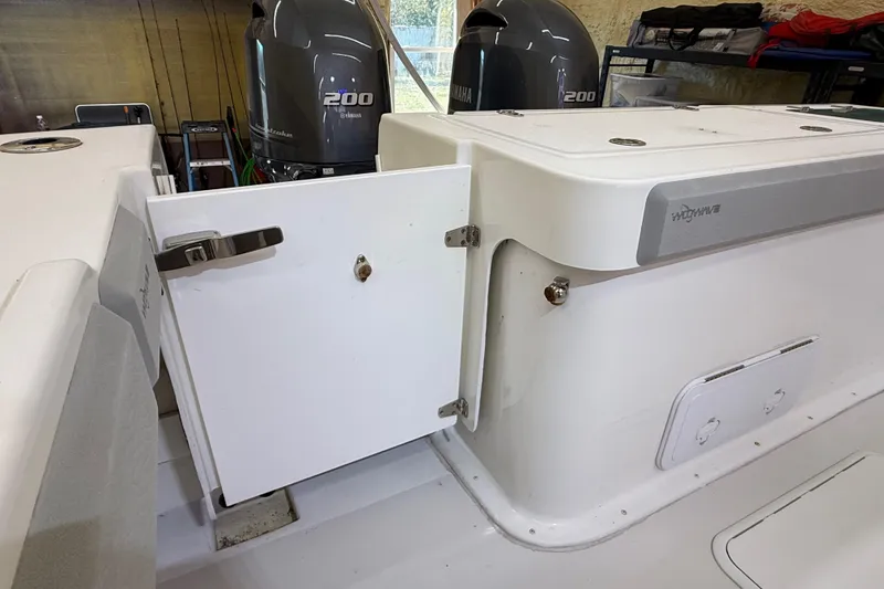 Slide: The Image of 2022 Parker 2501 Center Console boat with Yamaha 200 engines, open storage compartment. - 34