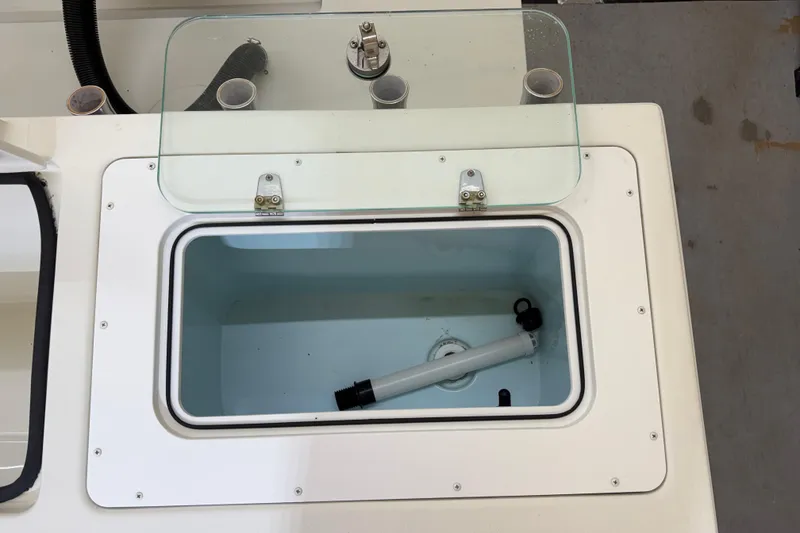 Slide: The Image of Open storage compartment on 2022 Parker 2501 Center Console boat. - 38