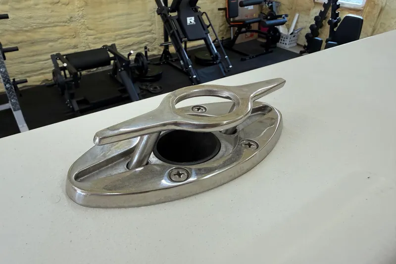 Slide: The Image of Stainless steel cleat on 2022 Parker 2501 Center Console boat, gym equipment in background. - 40