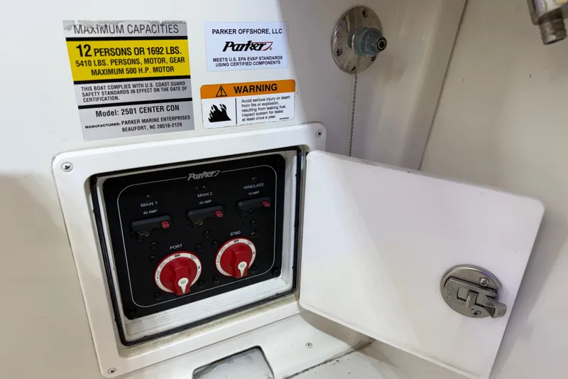 Slide: The Image of Control panel of 2022 Parker 2501 Center Console boat with capacity and safety labels. - 41