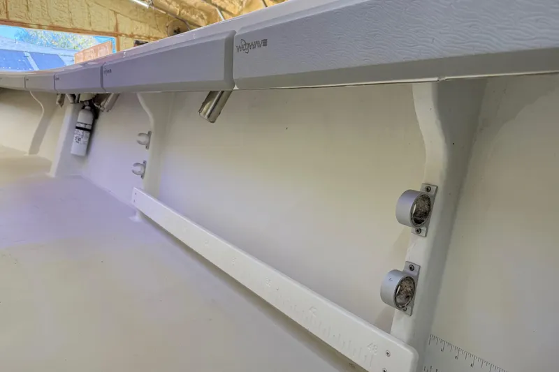 Slide: The Image of 2022 Parker 2501 Center Console boat interior with rod holders and storage compartments. - 45