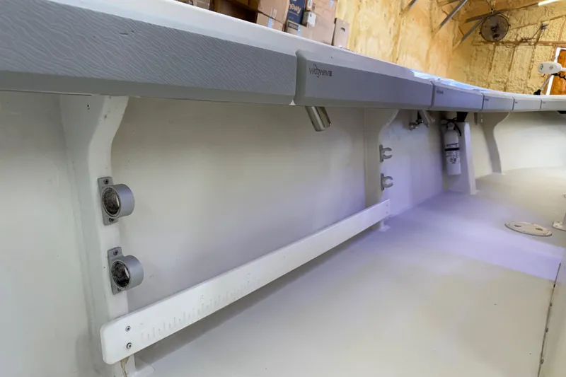 Slide: The Image of 2022 Parker 2501 Center Console boat interior, featuring rod holders and storage space. - 46