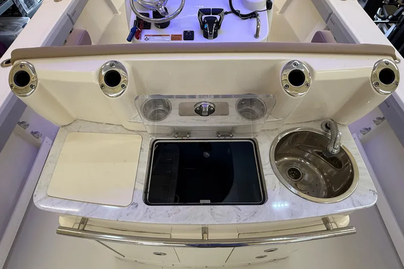 Slide: The Image of 2022 Parker 2501 Center Console boat interior with sink and storage compartments. - 48