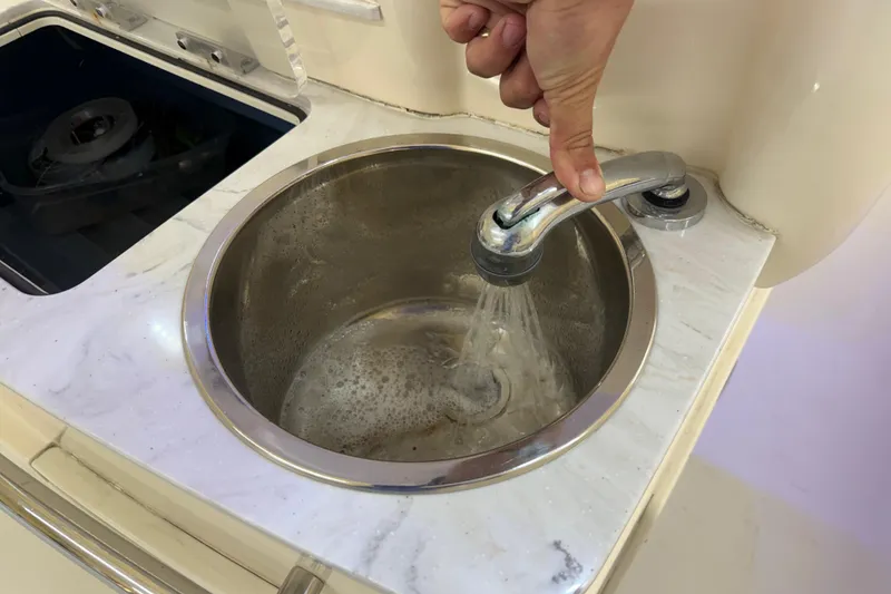 Slide: The Image of Stainless steel sink with running water on Parker 2501 Center Console boat, 2022 model. - 49