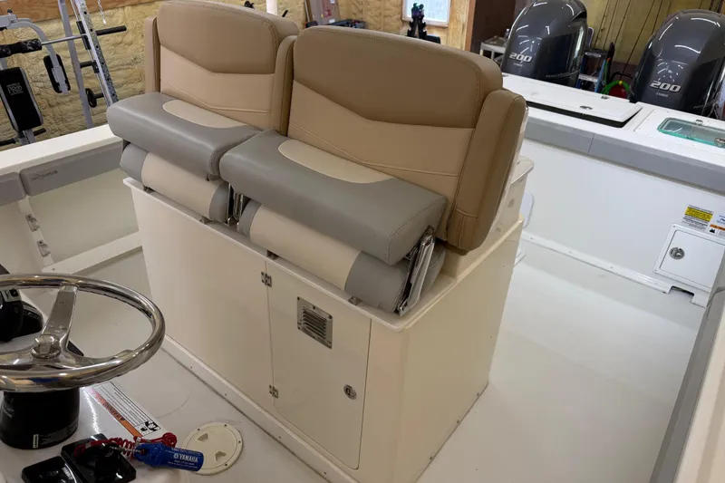 Slide: The Image of 2022 Parker 2501 Center Console boat interior with dual seats and steering wheel. - 53