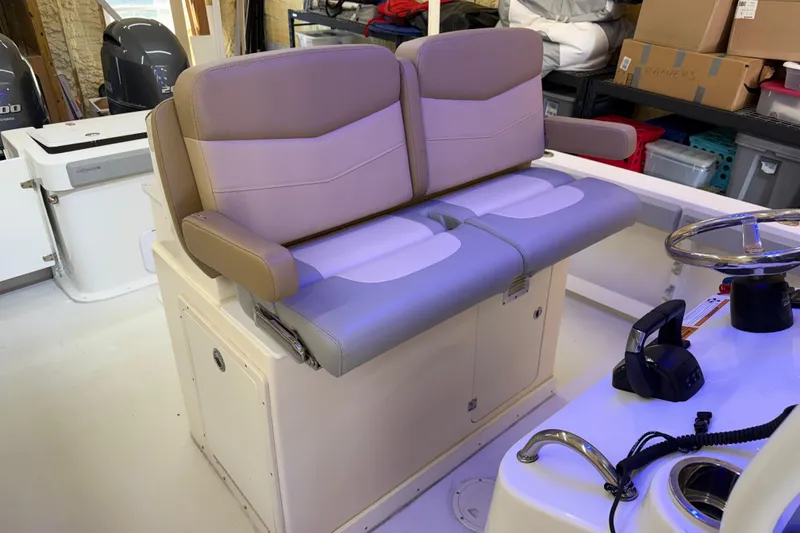 Slide: The Image of 2022 Parker 2501 Center Console boat interior with dual seating and steering wheel. - 54