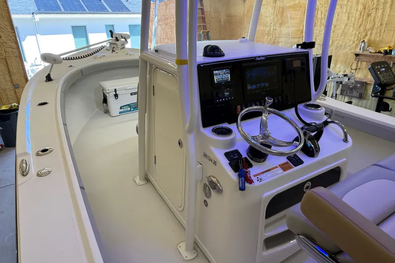 Slide: The Image of 2022 Parker 2501 Center Console boat interior with steering wheel and control panel. - 56