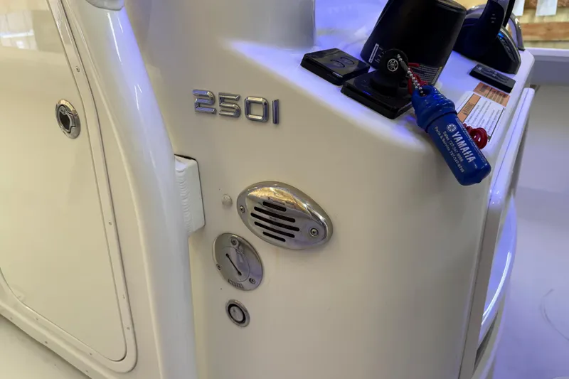 Slide: The Image of 2022 Parker 2501 Center Console boat dashboard with Yamaha key and controls. - 57