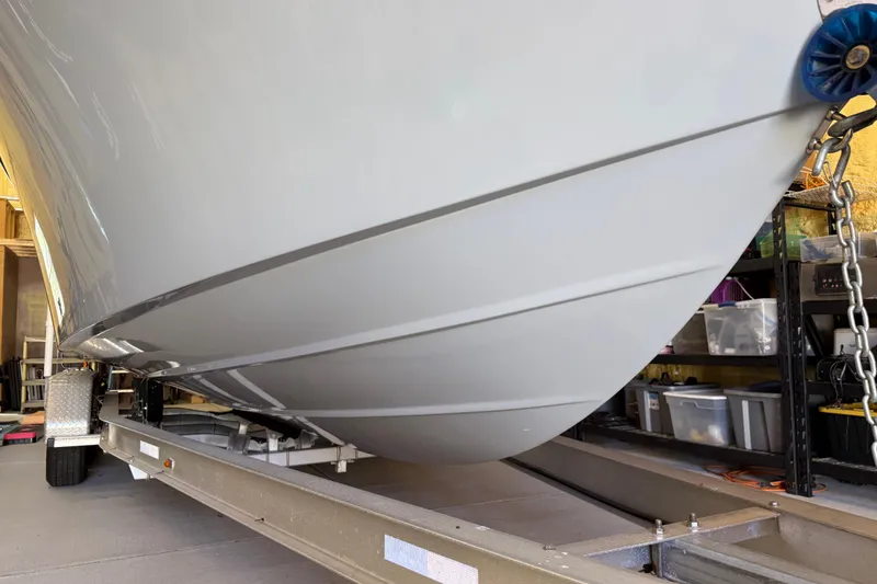 Slide: The Image of 2022 Parker 2501 Center Console boat on trailer in storage garage. - 6