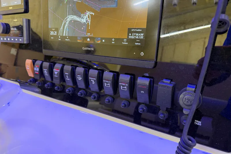 Slide: The Image of Control panel of a 2022 Parker 2501 Center Console boat with Garmin navigation display. - 65