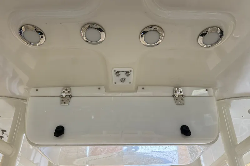 Slide: The Image of 2022 Parker 2501 Center Console boat interior with lights and storage compartment. - 68