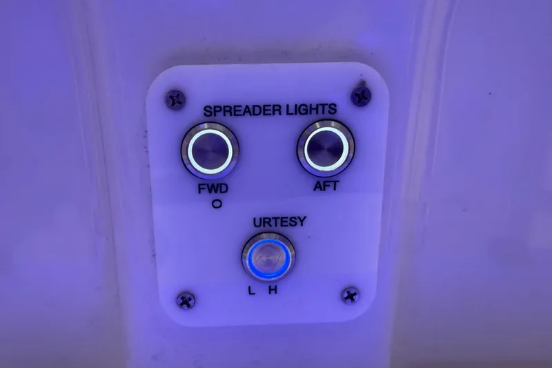 Slide: The Image of Control panel for spreader and courtesy lights on 2022 Parker 2501 Center Console boat. - 69