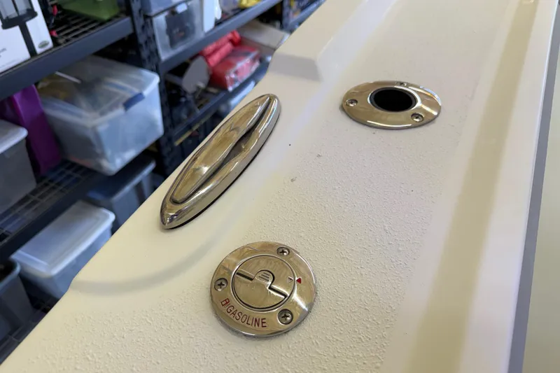 Slide: The Image of Fuel cap and fittings on a 2022 Parker 2501 Center Console boat. - 70