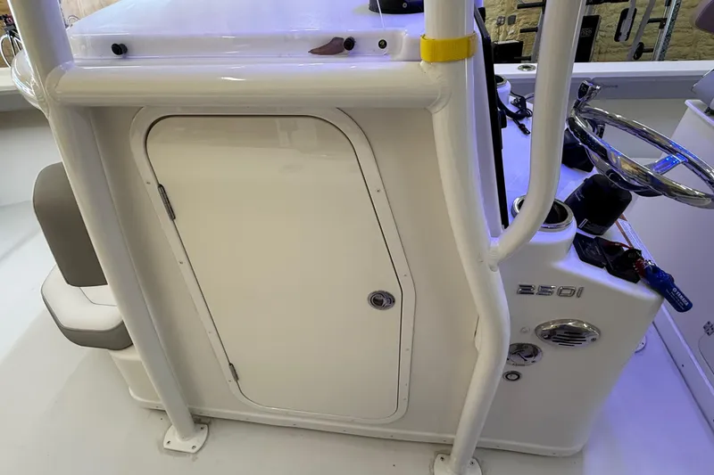 Slide: The Image of 2022 Parker 2501 Center Console boat interior with steering wheel and storage compartment. - 71