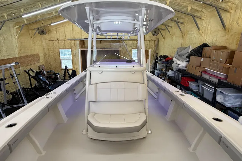 Slide: The Image of 2022 Parker 2501 Center Console boat in a storage garage with organized shelves. - 77