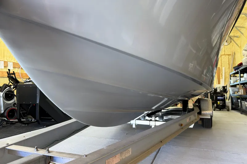 Slide: The Image of 2022 Parker 2501 Center Console boat on trailer in garage setting. - 8