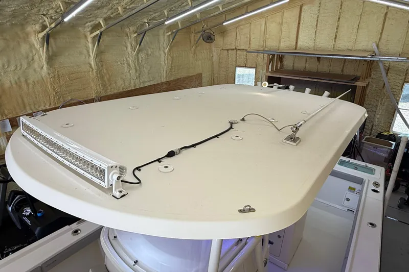 Slide: The Image of 2022 Parker 2501 Center Console boat roof with mounted light bar in a workshop. - 82