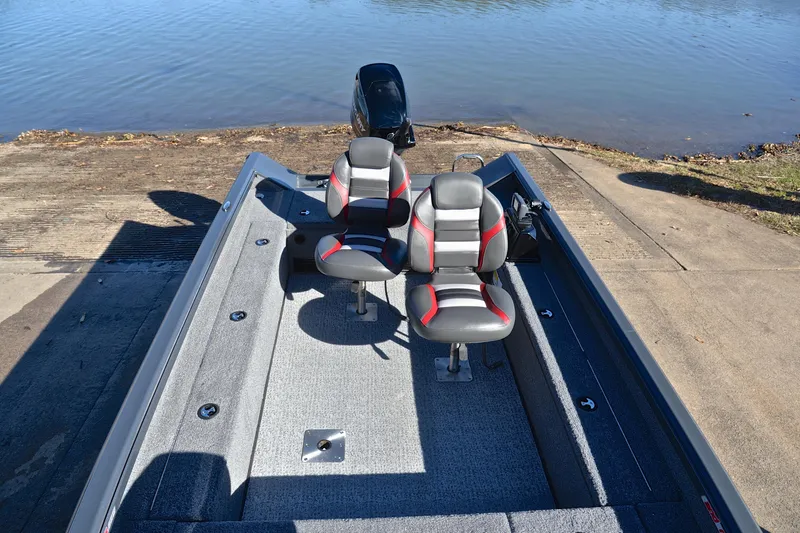 Slide: The Image of 2021 Ranger VS1660 T fishing boat with dual seats at a lakeside launch. - 22