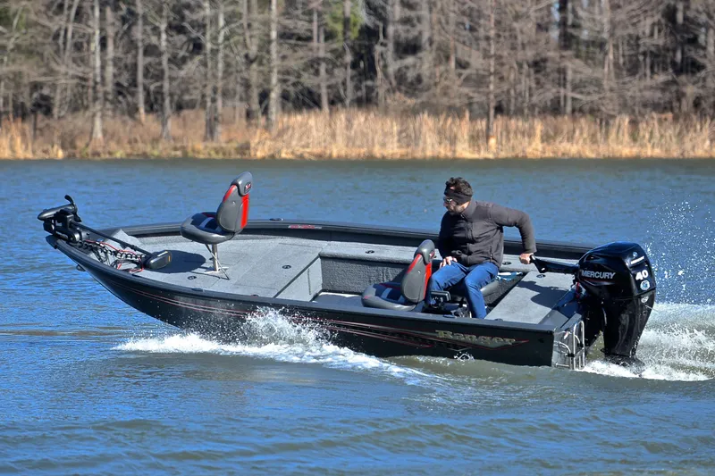 Slide: The Image of 2021 Ranger VS1660 T boat cruising on a lake with a Mercury engine. - 5