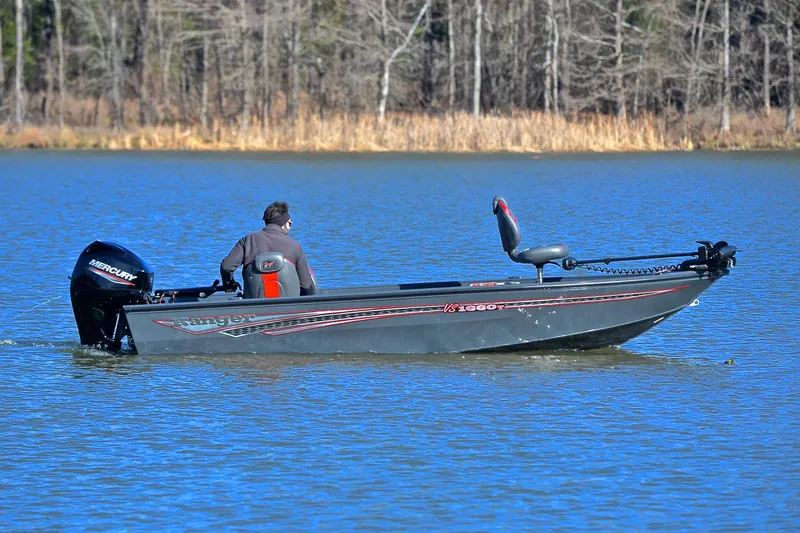 Slide: The Image of 2021 Ranger VS1660 T boat on a lake with a Mercury engine. - 7