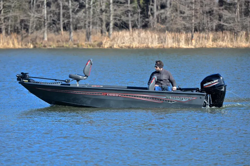 Slide: The Image of 2021 Ranger VS1660 T boat on a lake with a Mercury engine. - 9