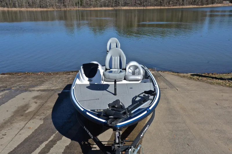 Slide: The Image of 2018 Nitro Z17 boat on a concrete ramp by a calm lake. - 17