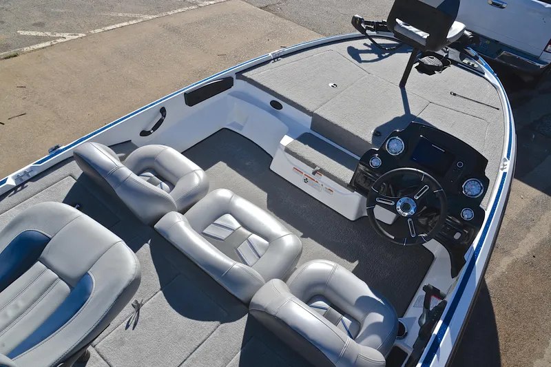Slide: The Image of 2018 Nitro Z17 boat interior with gray seating and modern dashboard. - 20