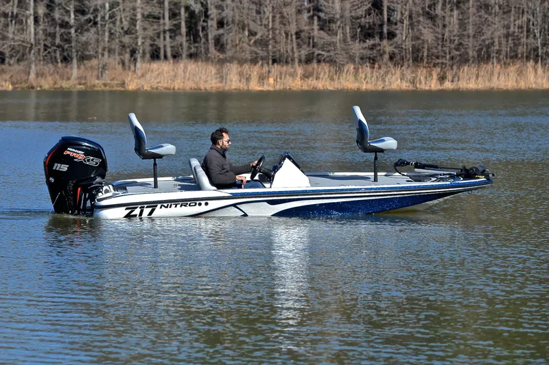 Slide: The Image of Man driving a 2018 Nitro Z17 boat on a calm lake. - 7