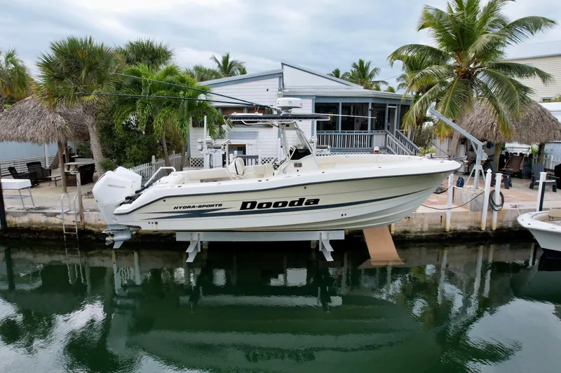 The Image of 2003 Hydra-Sports Vector 2800 CC boat docked by a tropical waterfront home. - 1