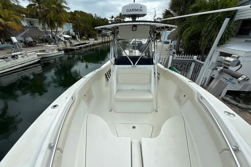 Slide: The Image of 2003 Hydra-Sports Vector 2800 CC boat docked near palm trees and waterfront homes. - 10