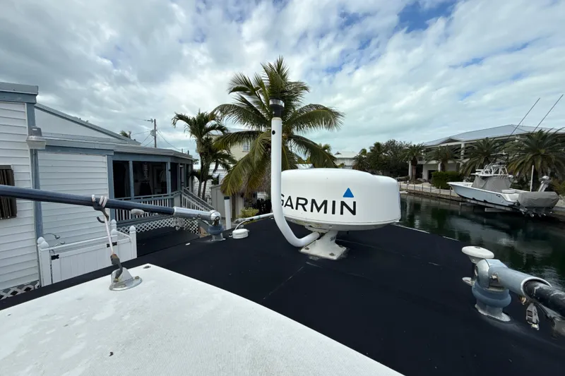 Slide: The Image of 2003 Hydra-Sports Vector 2800 CC with Garmin radar, docked near palm trees and waterfront homes. - 12
