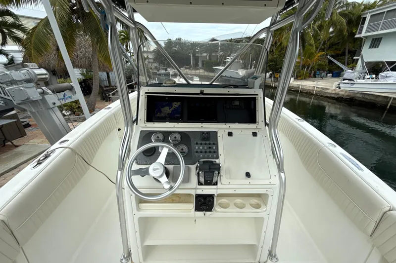 Slide: The Image of 2003 Hydra-Sports Vector 2800 CC boat cockpit with steering wheel and control panel. - 6