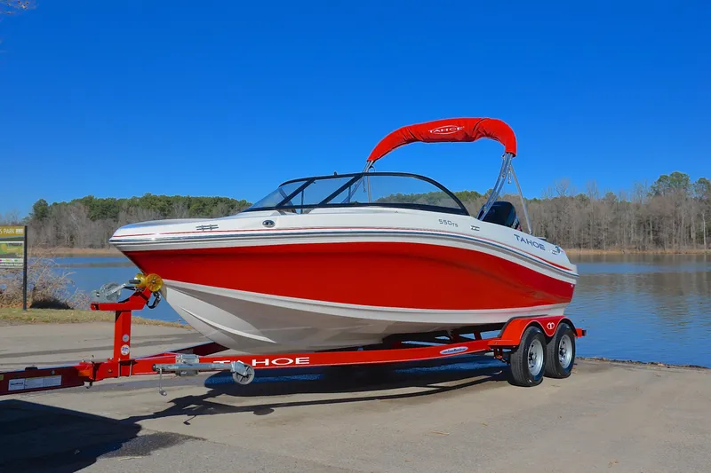 Slide: The Image of Red 2016 Tahoe 550 TS boat on trailer by lake. - 10