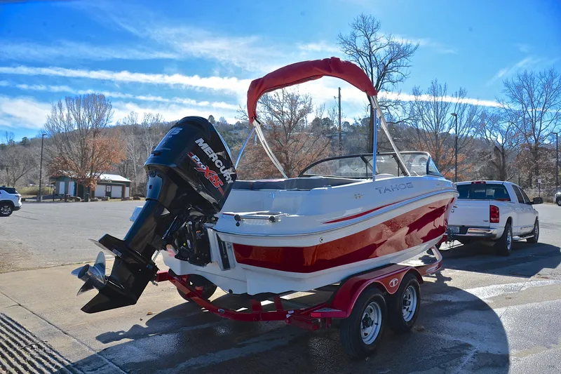 Slide: The Image of 2016 Tahoe 550 TS boat on trailer, parked outdoors with clear blue sky. - 14