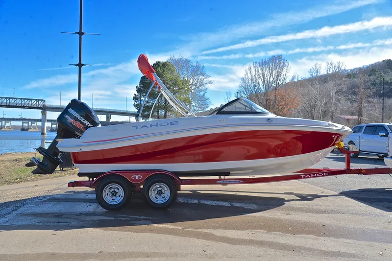 Slide: The Image of 2016 Tahoe 550 TS boat on trailer by riverside, clear sky background. - 15
