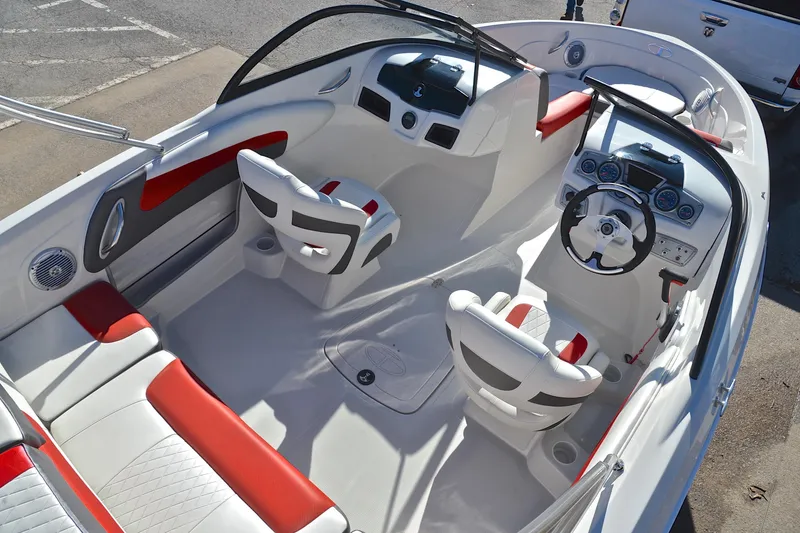 Slide: The Image of Interior of 2016 Tahoe 550 TS boat with white and red seating, steering console. - 19