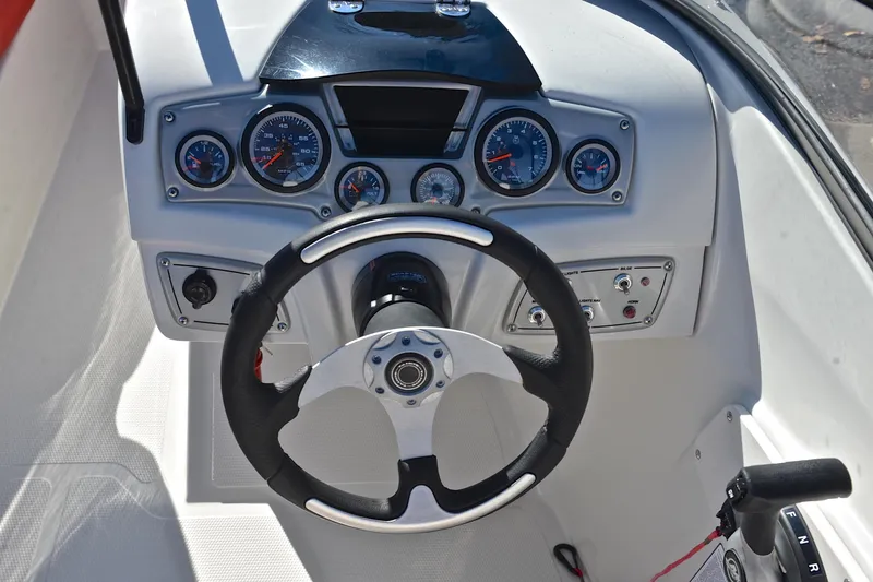 Slide: The Image of Steering console of a 2016 Tahoe 550 TS boat with gauges and controls. - 25