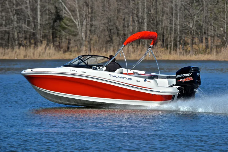 Slide: The Image of 2016 Tahoe 550 TS boat cruising on a lake with red canopy. - 4