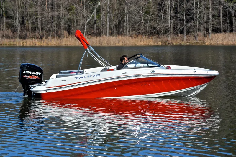 Slide: The Image of 2016 Tahoe 550 TS boat on a calm lake. - 7