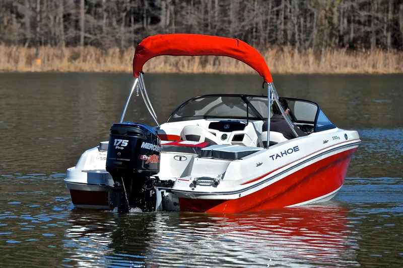 Slide: The Image of 2016 Tahoe 550 TS boat on a calm lake. - 8