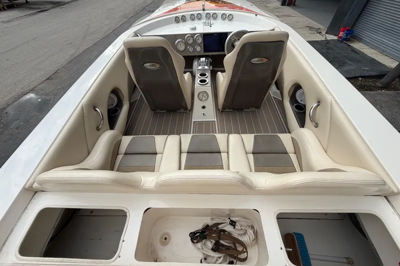 Slide: The Image of Interior of 2000 Spectre 30 Cat boat with beige seating and dashboard controls. - 10