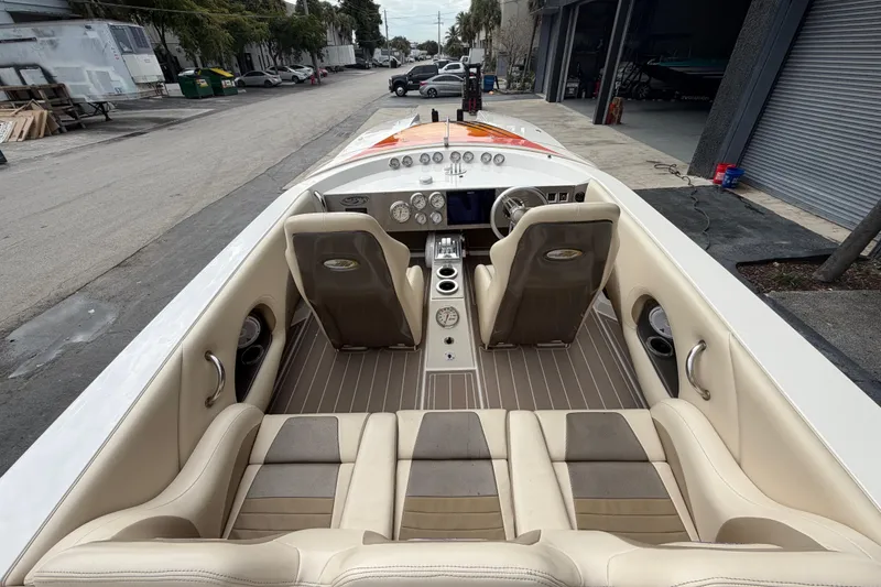 Slide: The Image of Interior view of a 2000 Spectre 30 Cat boat with beige seating and dashboard. - 11