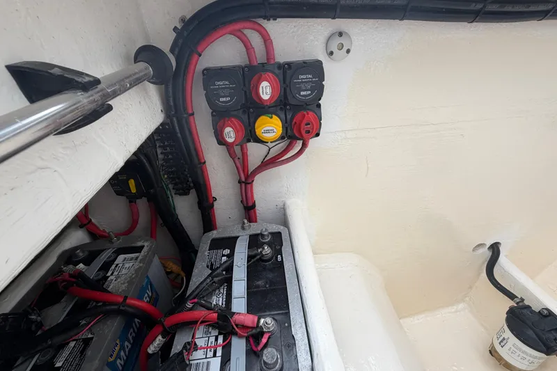 Slide: The Image of Battery compartment of a 2000 Spectre 30 Cat boat with wiring and switches. - 12