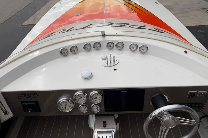 Slide: The Image of Dashboard of a 2000 Spectre 30 Cat boat with gauges and steering wheel. - 4