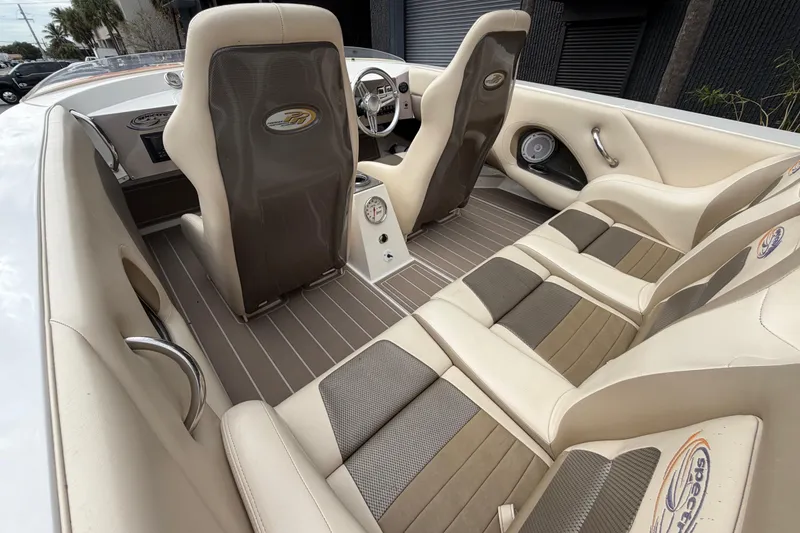 Slide: The Image of Interior of a 2000 Spectre 30 Cat boat with beige and gray seating. - 9