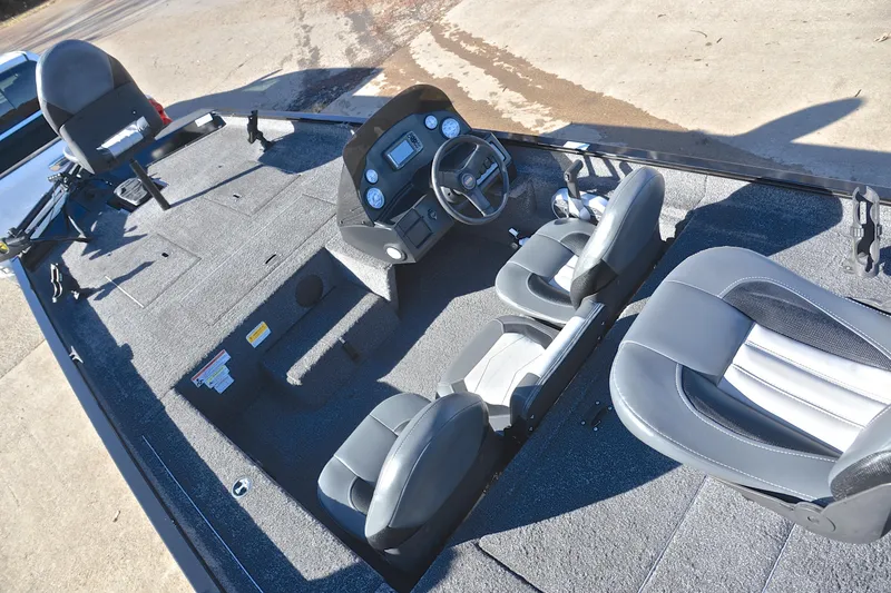 Slide: The Image of 2021 Lowe Legacy boat interior with steering console and seating. - 19