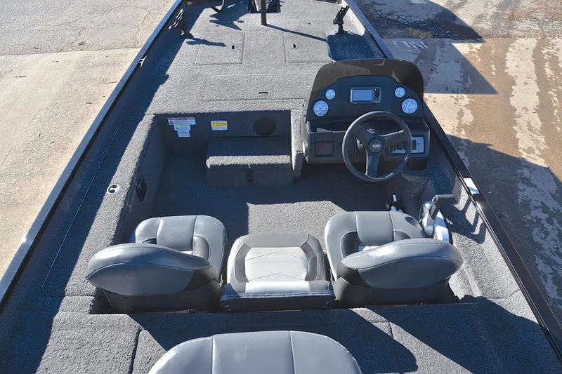 Slide: The Image of 2021 Lowe Legacy boat interior with steering console and seating. - 21