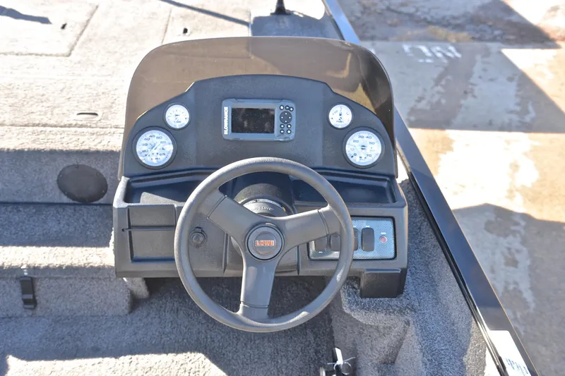 Slide: The Image of 2021 Lowe Legacy boat dashboard with steering wheel and gauges. - 22