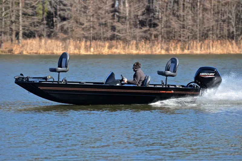 Slide: The Image of 2021 Lowe Legacy boat speeding on a lake with a Mercury engine. - 24